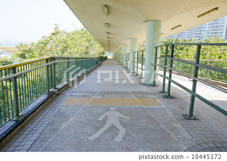 walkway with a metal handrail. 18445172