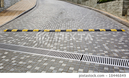 Traffic safety speed bump on an asphalt road 18446849