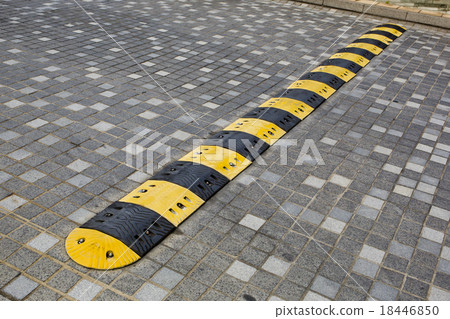Traffic safety speed bump on an asphalt road 18446850