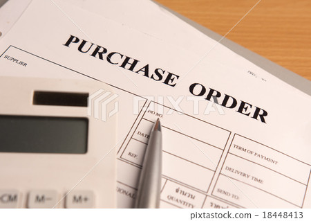 Purchase order form with pen on wooden table