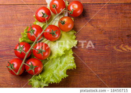Fresh, ripe cherry tomatoes on an old wood Fresh, ripe cherry tomatoes on an old wood 18450715