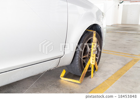 Car wheel clamped for illegal parking at car park 18453848