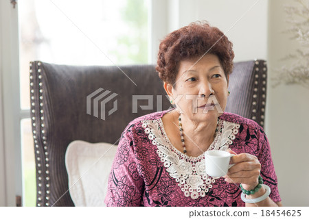 Happy Asian senior woman drinking tea at home. 18454625