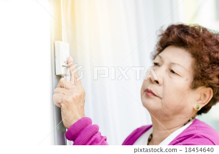 Asian senior is ringing door bell. Asian senior is ringing door bell. 18454640