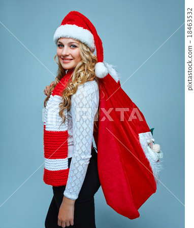Girl dressed in santa hat holding a Christmas Girl dressed in santa hat holding a Christmas 18463532