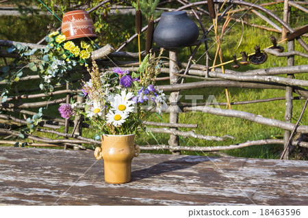 Bouquet of flowers in vase on rustic table 18463596