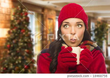 Mixed Race Woman Wearing Hat and Gloves In Christmas Setting 18468756