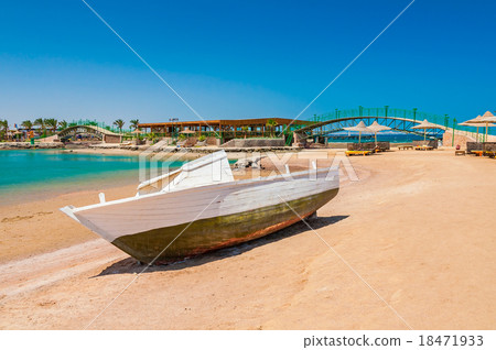 Old fishing boat on sand with blue sky and water Old fishing boat on sand with blue sky and water 18471933