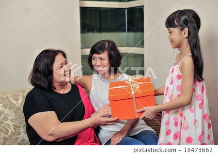 Asian family of three generation exchanging gifts 18473662