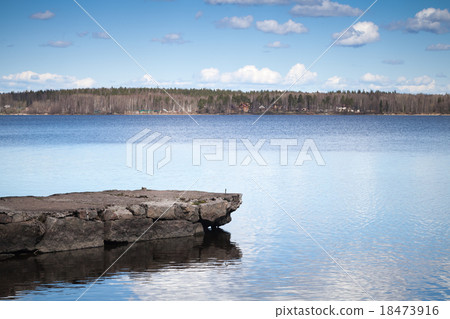 Still lake coastal landscape with old stone pier 18473916