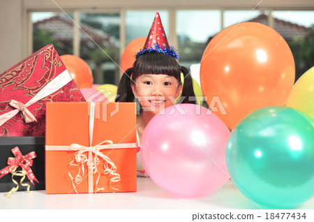 Happy Asian girl posing with balloons and presents Happy Asian girl posing with balloons and presents 18477434