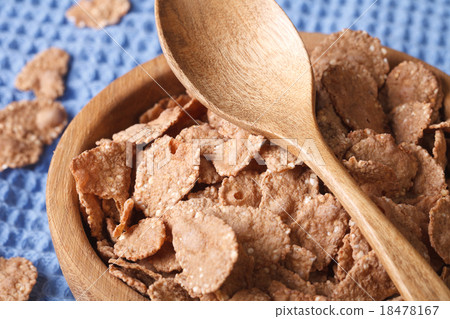 bran flakes in a wooden bowl closeup. horizontal 18478167