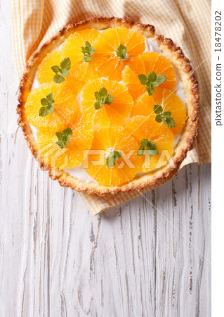 Orange tart with cream and mint. vertical top view Orange tart with cream and mint. vertical top view 18478202