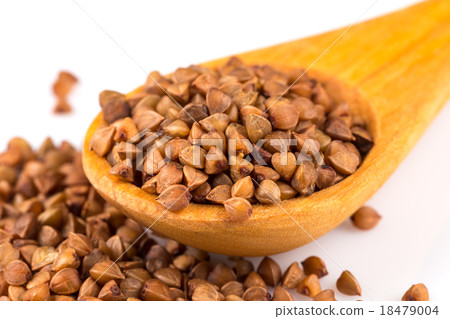 Uncooked buckwheat on wooden spoon 18479004