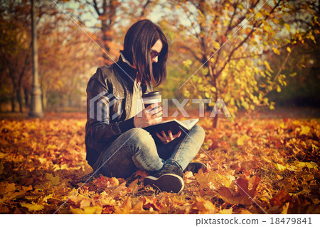 girl with coffee cup reading a book 18479841