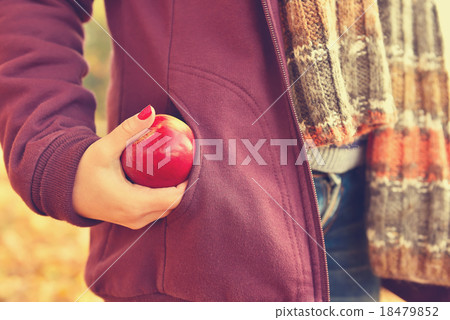 Girl pulls an apple Girl pulls an apple 18479852