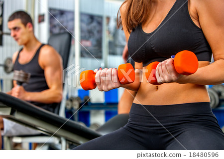 Group of people  working with dumbbells  at gym.  18480596