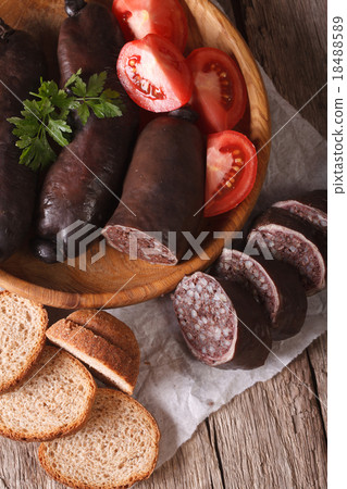 Fresh black pudding on a plate close-up top view Fresh black pudding on a plate close-up top view 18488589