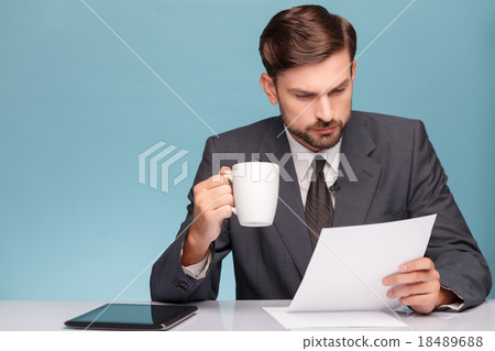 Attractive male newscaster with cup of tea 18489688