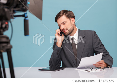Handsome male reporter is communication on the 18489729