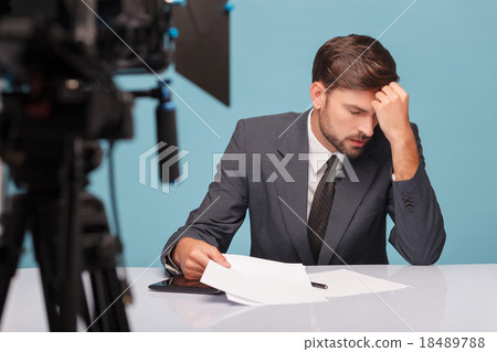 Handsome male newscaster is suffering from 18489788