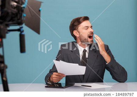 Attractive young newscaster is showing his 18489797