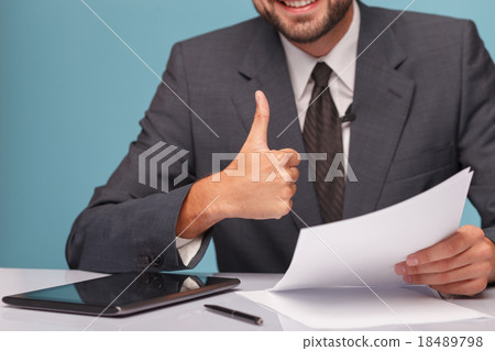 Cheerful male newscaster is showing okay sign 18489798