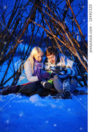 loving couple in a tent drinking tea in winter 18492320
