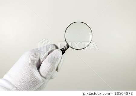 White glove holding magnifier. White glove holding magnifier. 18504878