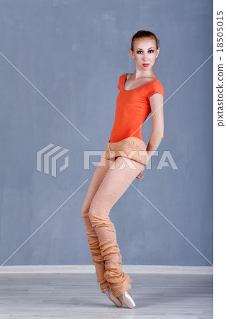 Slender ballerina rehearsing in dance movement 18505015
