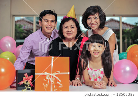 Grandma wearing a party hat at her birthday party 18505382