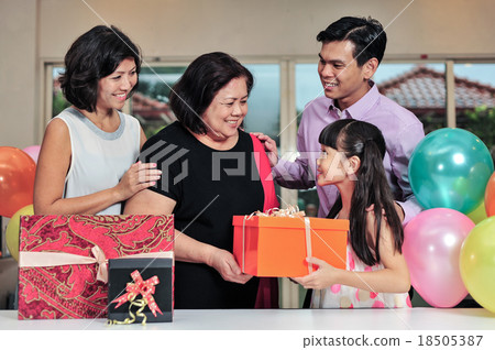 Grandma wearing a party hat at her birthday party 18505387