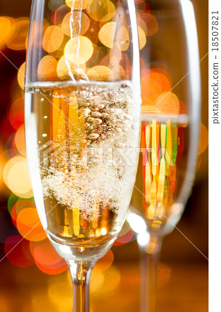 bubbles of Champagne against sparkling lights 18507821