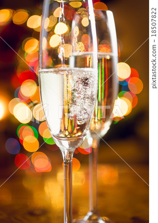 Macro of champagne poured in glass against lights 18507822