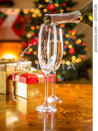 two champagne glasses on Christmas dining table two champagne glasses on Christmas dining table 18507826