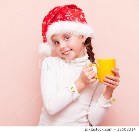 girl with cup in Santa Claus hat 18508314