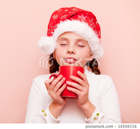 girl with cup in Santa Claus hat 18508316