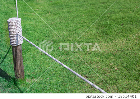 Layers of rope tied around a wooden log Layers of rope tied around a wooden log 18514401