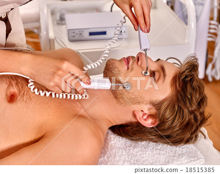 Man receiving electric facial peeling hydradermie Man receiving electric facial peeling hydradermie 18515385