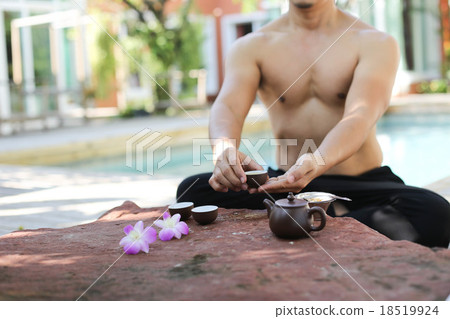 Man doing Yoga and pot of tea Man doing Yoga and pot of tea 18519924