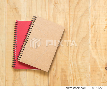 Top view of red and brown book on wooden table Top view of red and brown book on wooden table 18521276