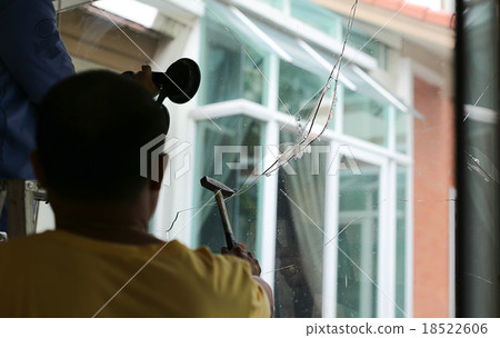 Repair man working on broken glass Repair man working on broken glass 18522606