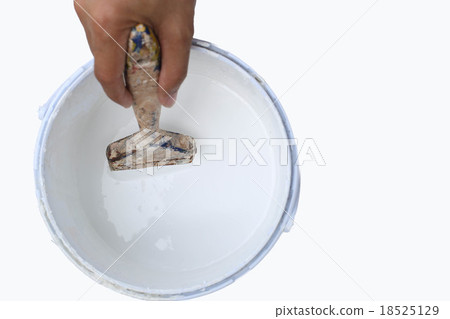 Hand holding paint brush in to  paint tin 18525129