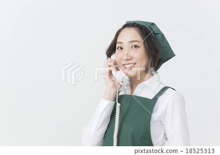 supermarket clerk with telephone receiver 18525313