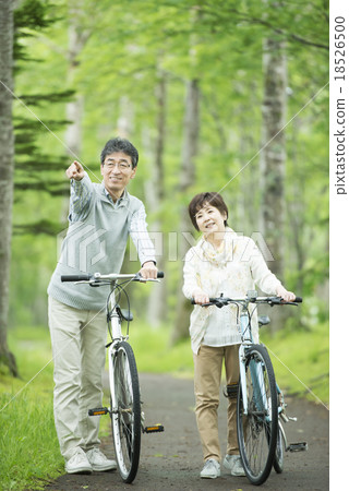 Senior couple pressing a bicycle 18526500