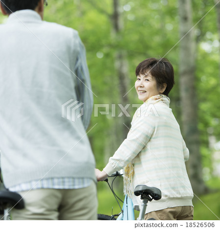 Senior couple pressing a bicycle Senior couple pressing a bicycle 18526506
