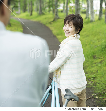 Senior couple pressing a bicycle Senior couple pressing a bicycle 18526507