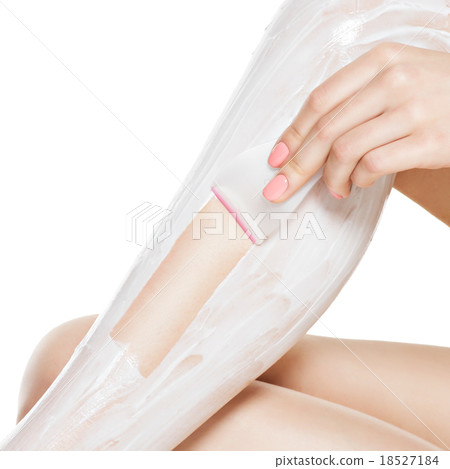 woman depilating legs by waxing 18527184