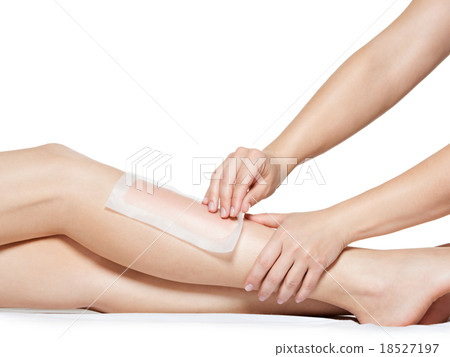 woman depilating legs by waxing 18527197