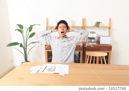 A man who puts a household account book A man who puts a household account book 18527798